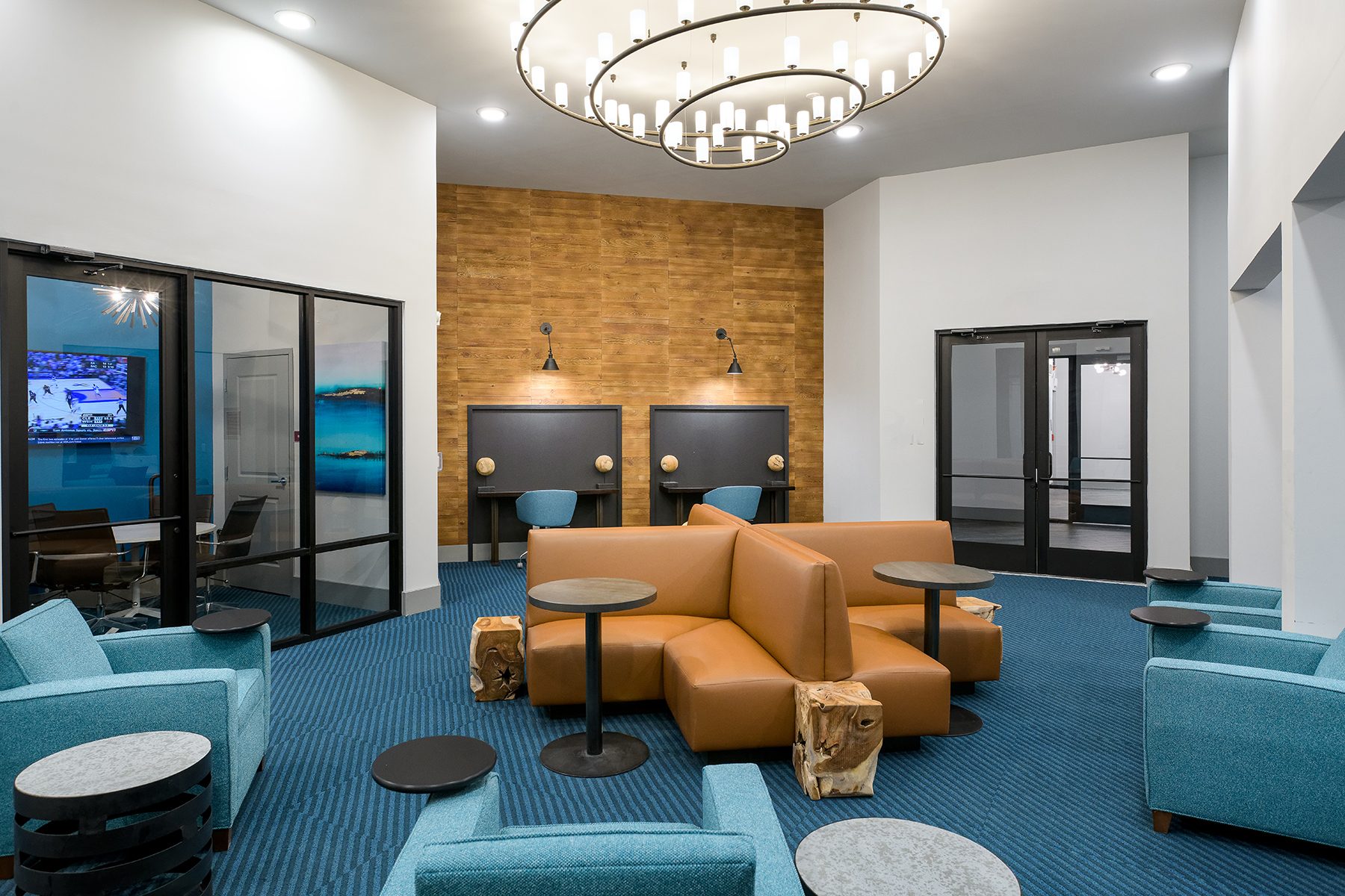 Reference photo of a modern fraternity-grade common lounge with leather seating and feature lighting